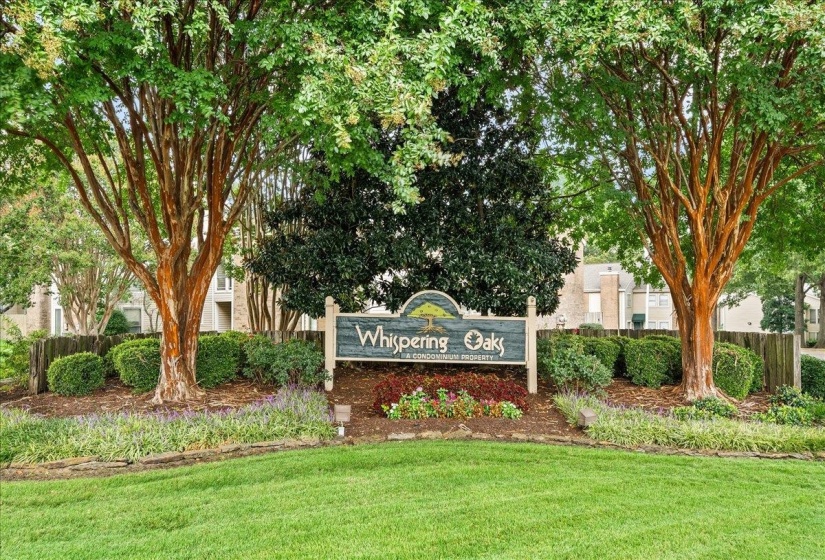 Community / neighborhood sign featuring a lawn