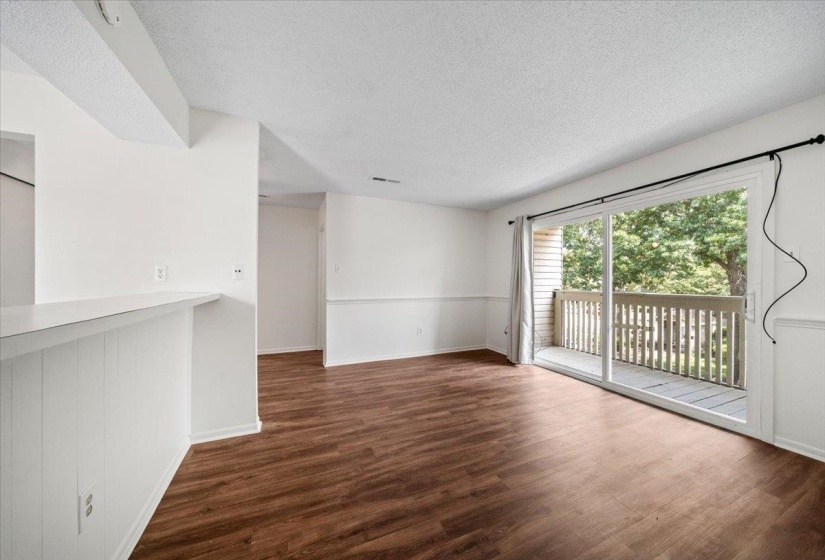 Empty room with dark wood-type flooring and a textured ceiling