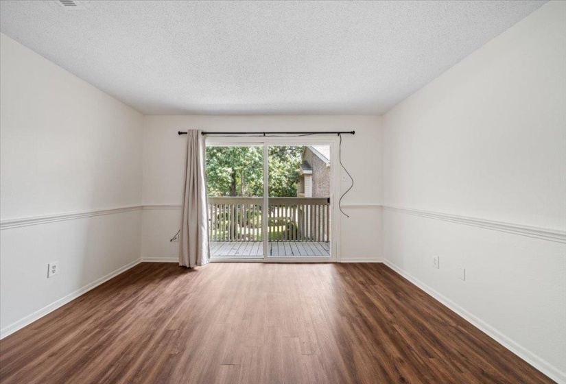 Empty room with dark wood-style floors and a textured ceiling