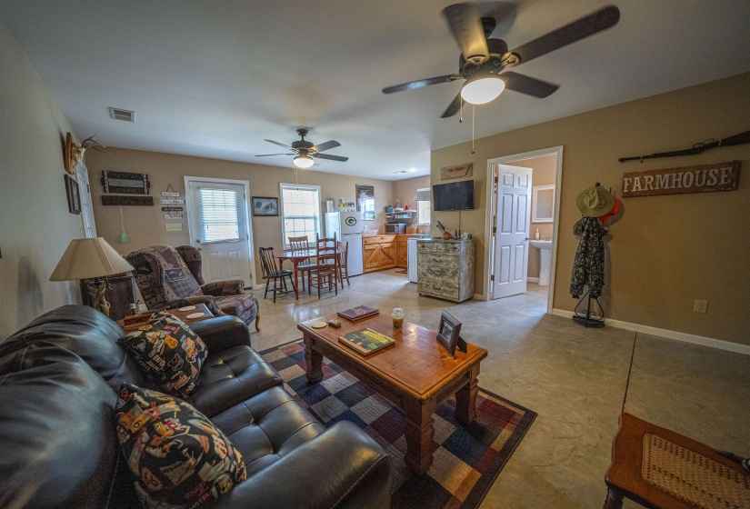 Living room featuring baseboards and ceiling fan