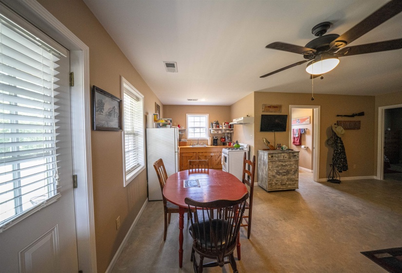 Dining area featuring finished concrete flooring and ceiling fan