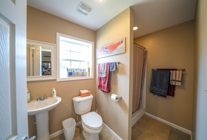 Full bath featuring a stall shower, light tile patterned floors, and recessed lighting