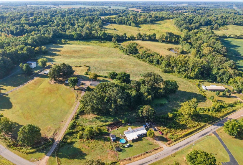 Aerial view of property and surrounding area featuring rural landscape