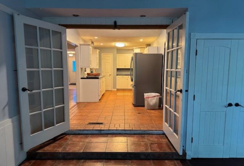 Kitchen featuring white cabinetry, dark countertops, and tile flooring