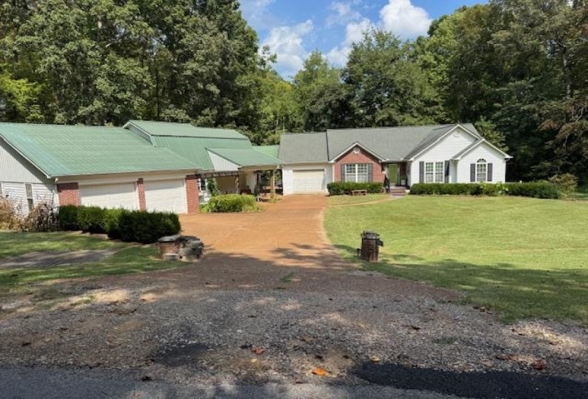 Ranch-style house with a front lawn, driveway, and a garage