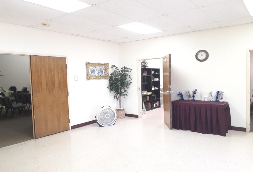 Interior space featuring a paneled ceiling and baseboards
