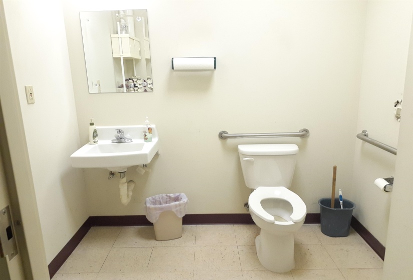 Half bathroom with baseboards and light tile patterned flooring
