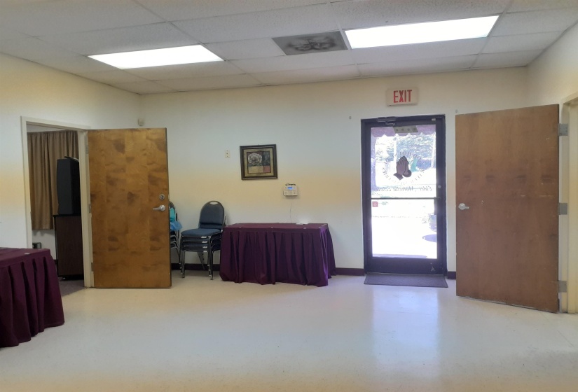 Misc room featuring a drop ceiling and finished concrete flooring
