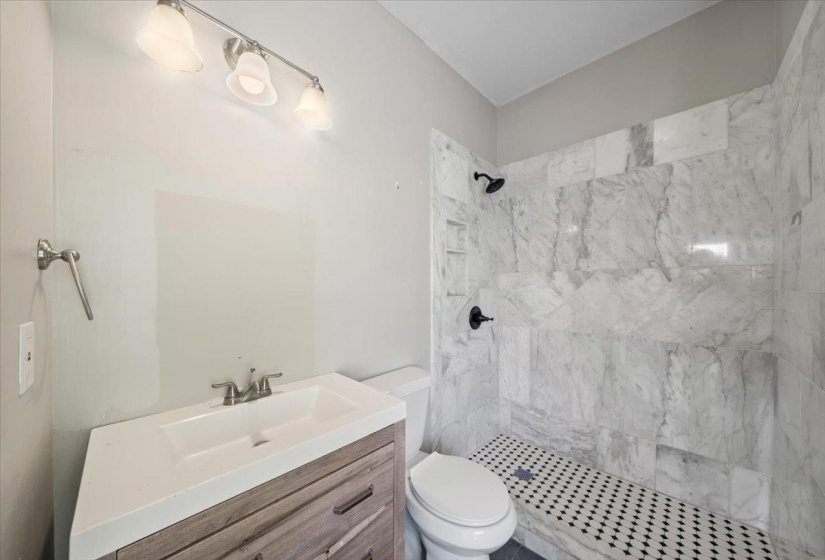 Bathroom featuring vanity and a shower stall