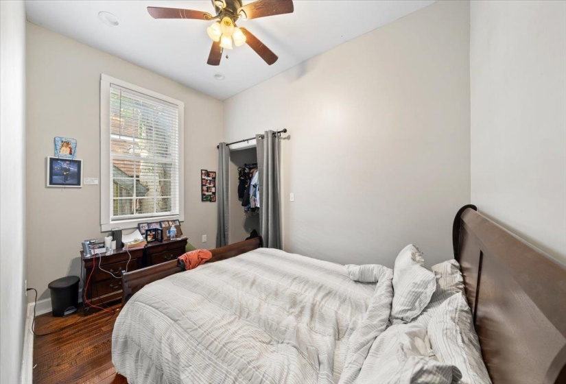Bedroom featuring wood finished floors and a ceiling fan