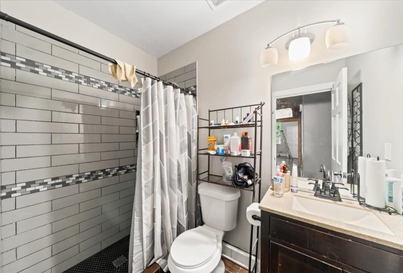 Full bath featuring a stall shower and vanity