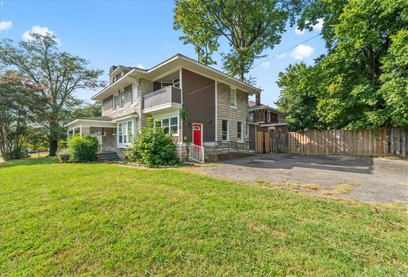 View of side of home featuring a balcony