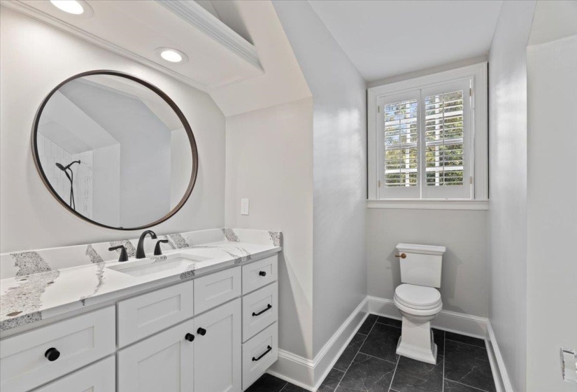 Bathroom featuring vanity and baseboards