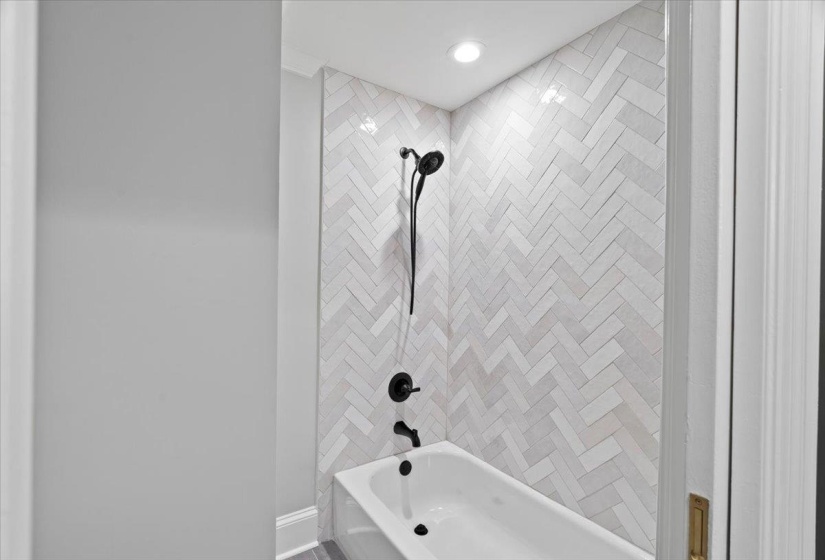 Full bathroom featuring shower / bath combination and baseboards