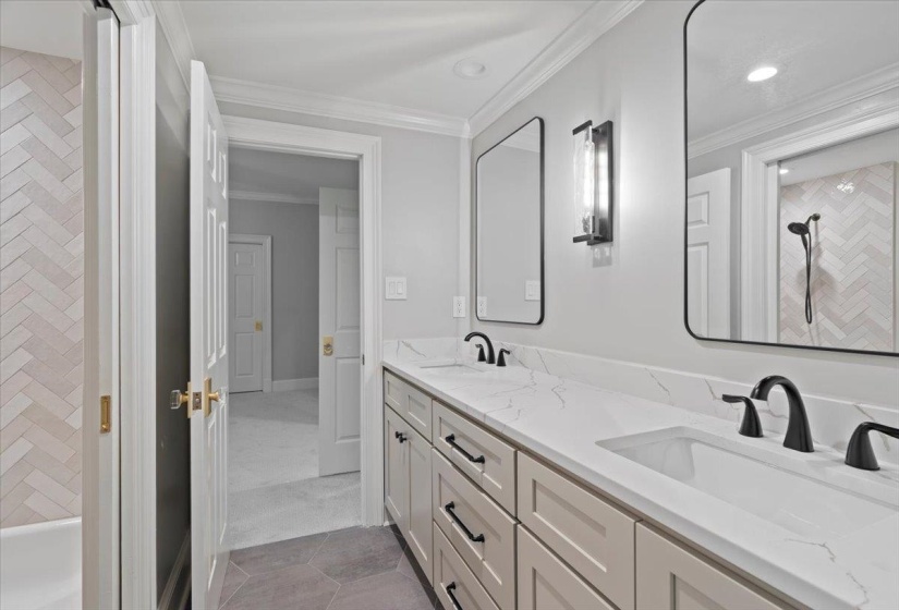 Bathroom with ornamental molding, double vanity, light tile patterned floors, and recessed lighting