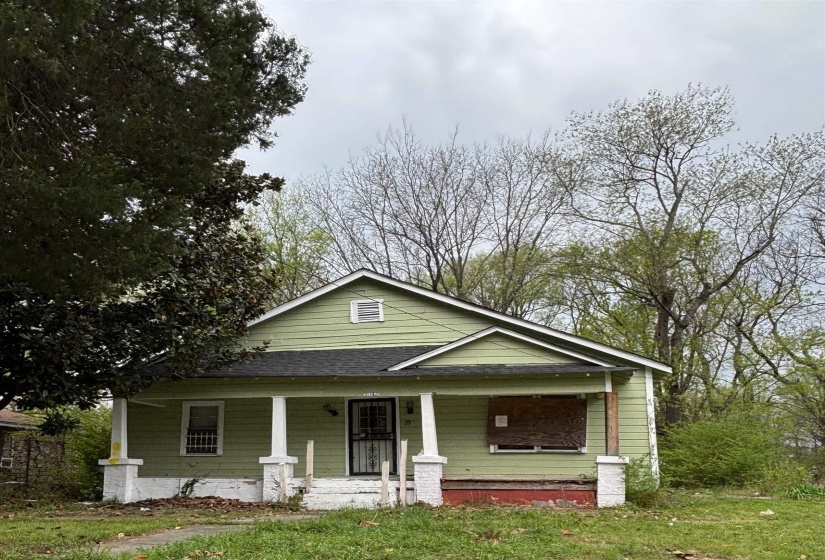 Bungalow-style house featuring a porch, roof with shingles, and a front yard