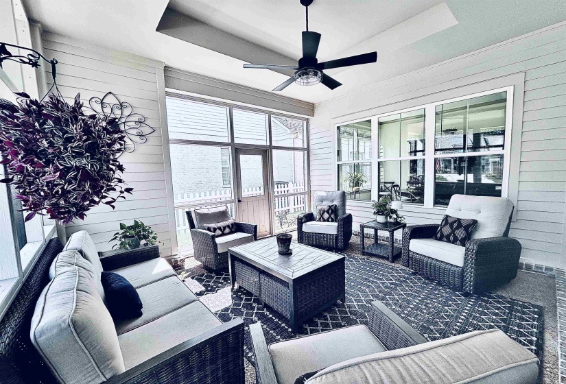 View of patio / terrace with an outdoor living space, ceiling fan, and a sunroom