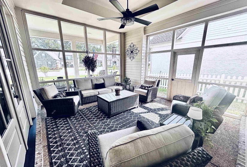 Sunroom with an outdoor living space and ceiling fan