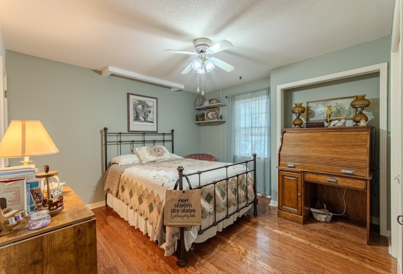 Bedroom featuring wood finished floors, ceiling fan, and a textured ceiling
