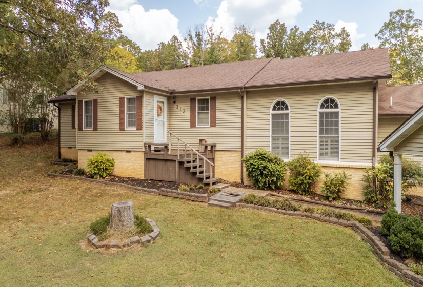 Ranch-style home featuring roof with shingles, a front yard, and crawl space