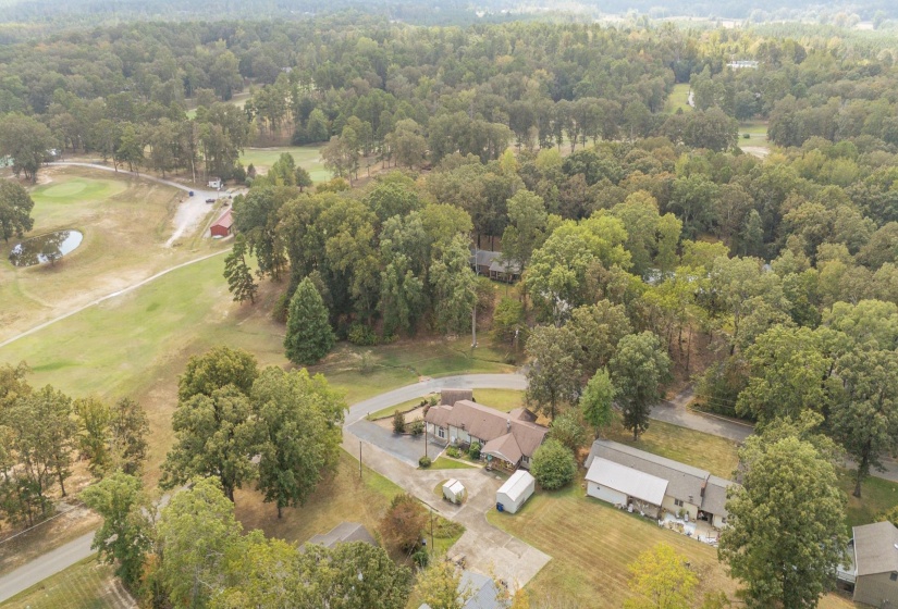 Aerial view of property and surrounding area with a golf course