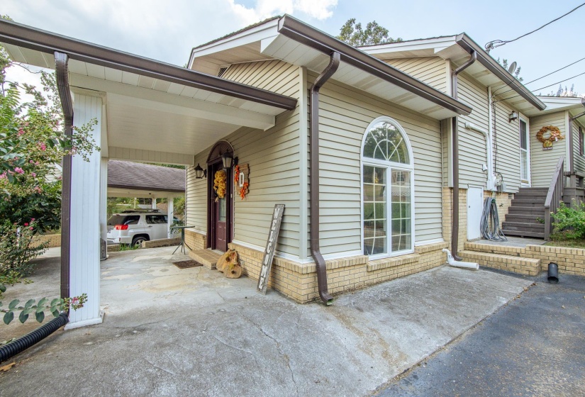 View of front of home featuring a carport and a patio