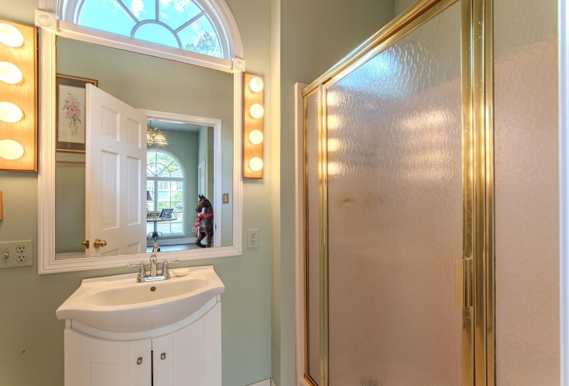 Bathroom featuring a shower stall and vanity
