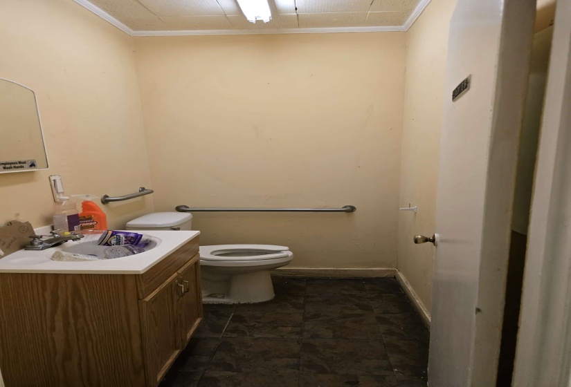 Half bathroom featuring vanity and ornamental molding