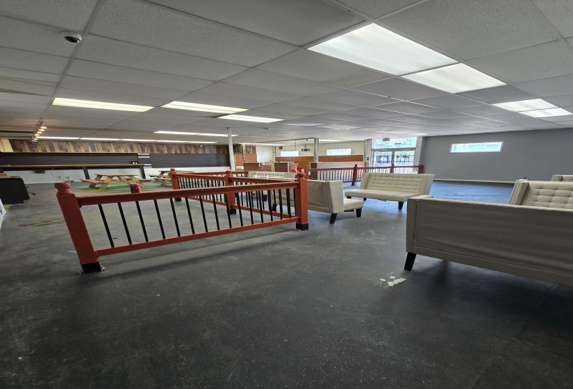 Lobby with a paneled ceiling and concrete flooring