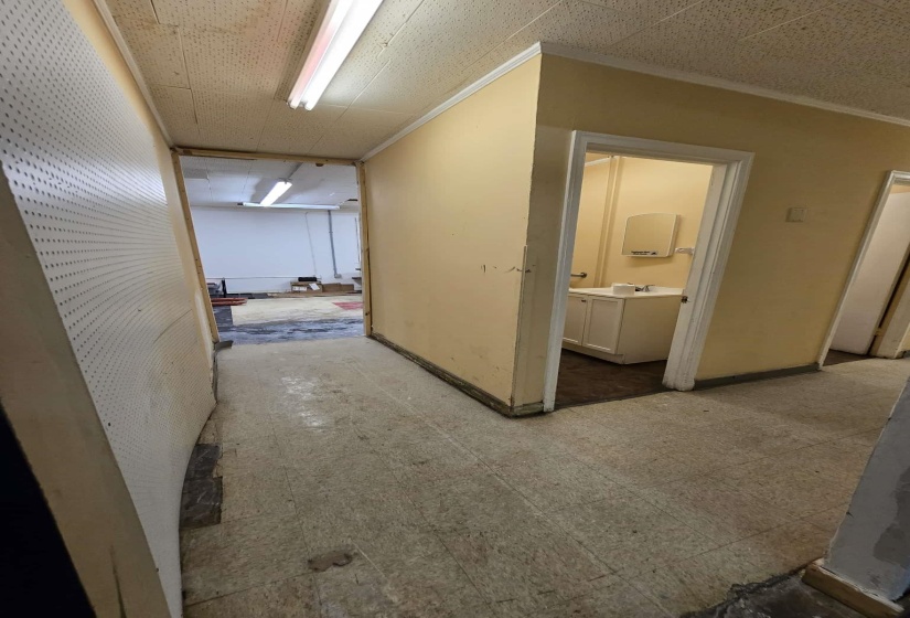 Corridor featuring crown molding and baseboards