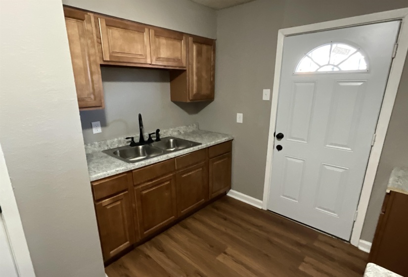 Kitchen with sink and dark hardwood / wood-style floors