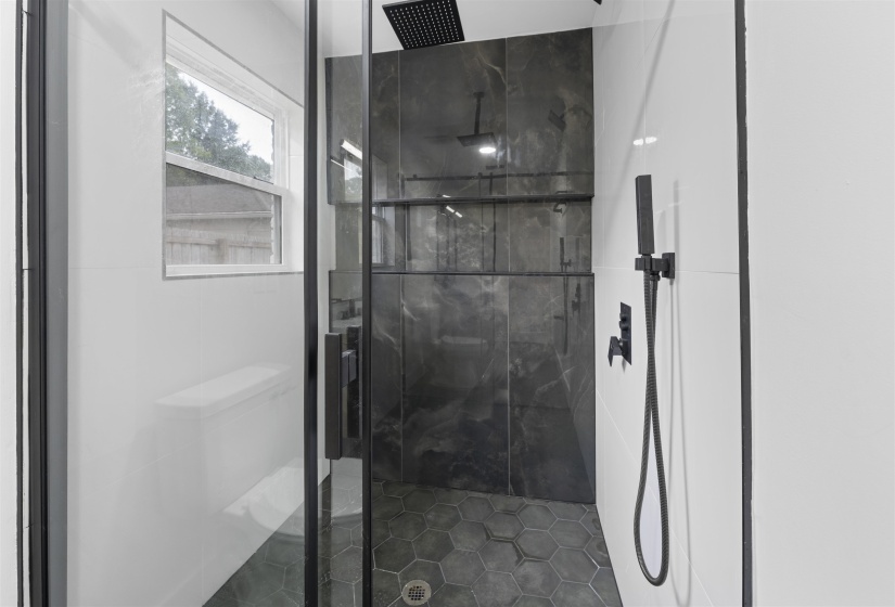 Full bath featuring a marble finish shower