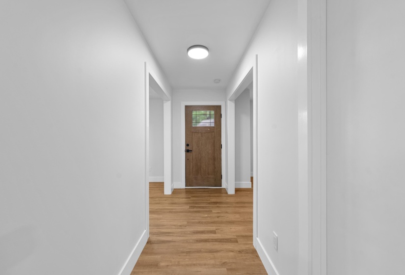 Hall with baseboards and light wood-type flooring