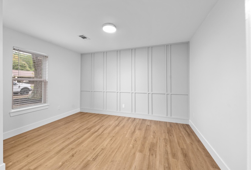 Spare room featuring light wood finished floors and baseboards