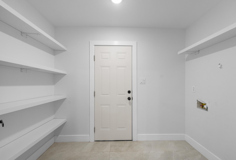 Laundry area featuring hookup for a washing machine and light tile patterned floors