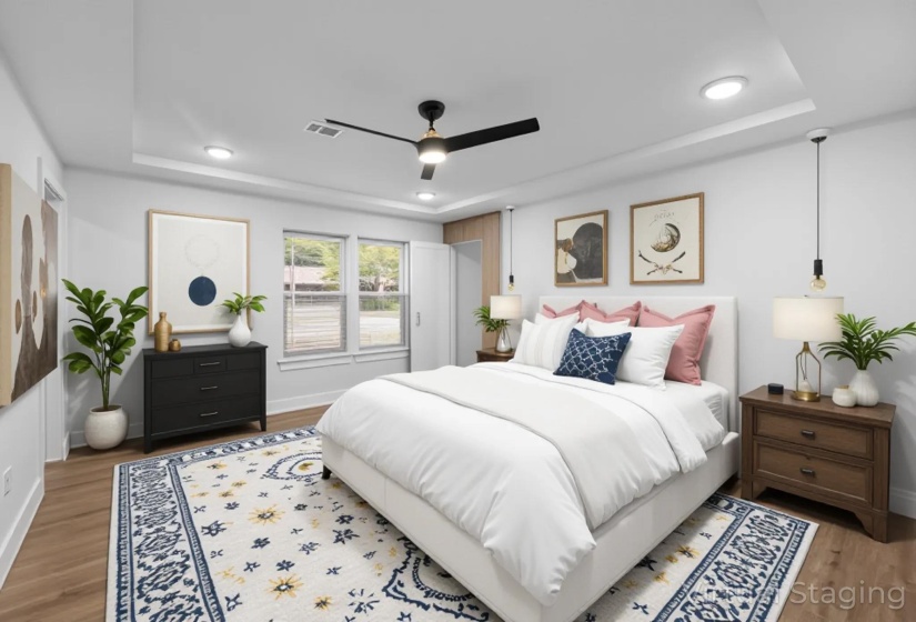 Bedroom with a tray ceiling, light wood-type flooring, a ceiling fan, and recessed lighting