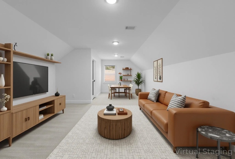 Media Room with lofted ceiling and light carpet