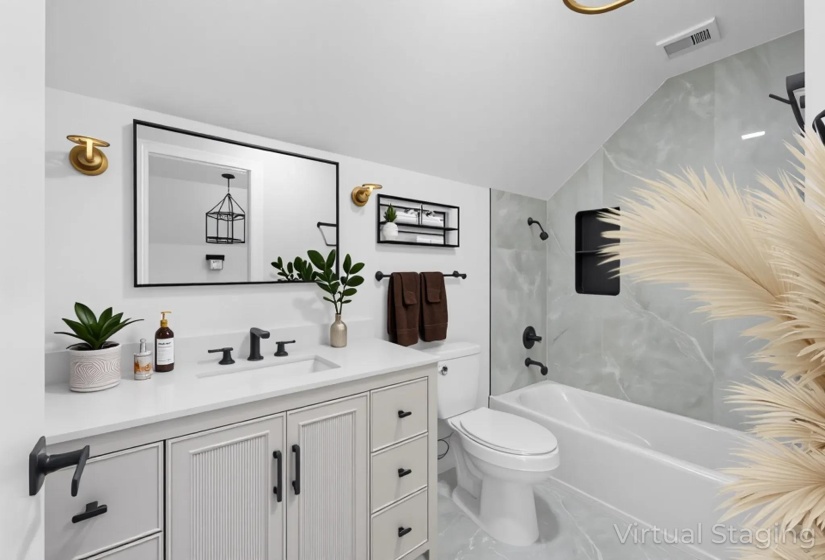 Full bath with shower / tub combination, vanity, and lofted ceiling