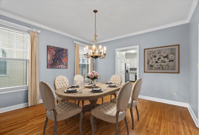 Dining room featuring ornamental molding, light wood finished floors, and a chandelier