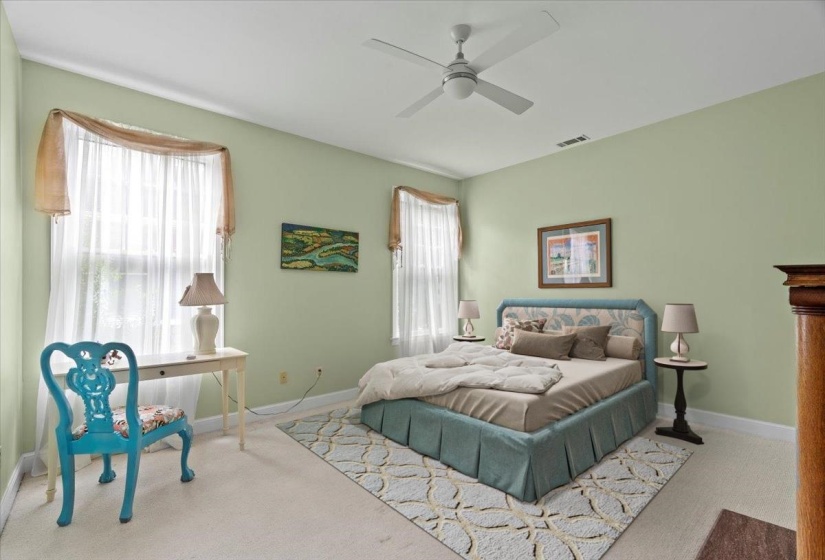 Carpeted bedroom featuring baseboards and ceiling fan