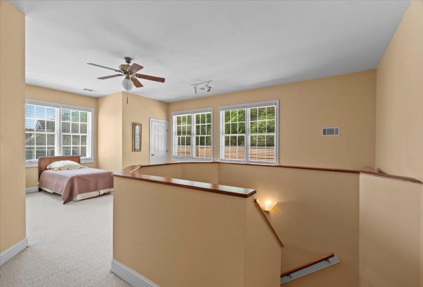 Unfurnished bedroom featuring carpet flooring and ceiling fan