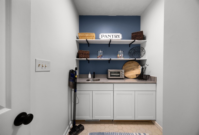 Pantry with Loads of storage, open shelves, and Quartzite countertops