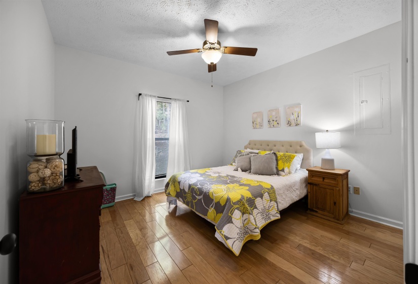 Bedroom featuring hardwood / wood-style floors, ceiling fan