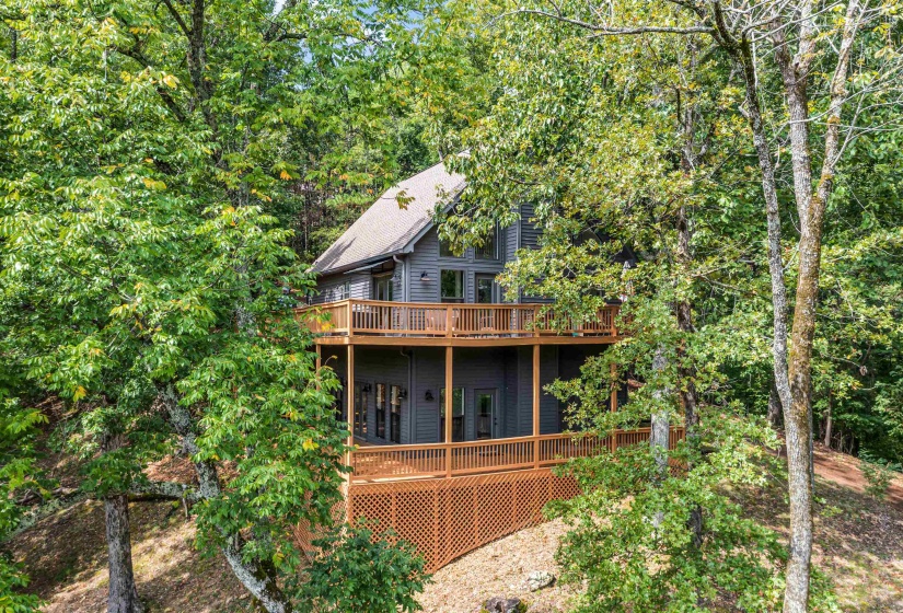 Front view of home featuring 2 story porches that overlook year round water views.