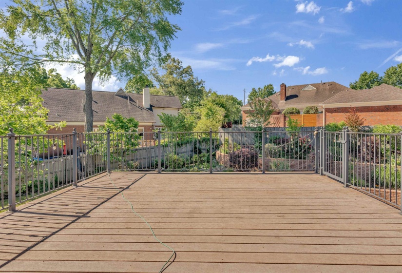 Spacious outdoor deck with composite decking and dark metal railings