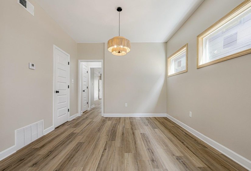 Unfurnished dining area with light wood finished floors and a chandelier