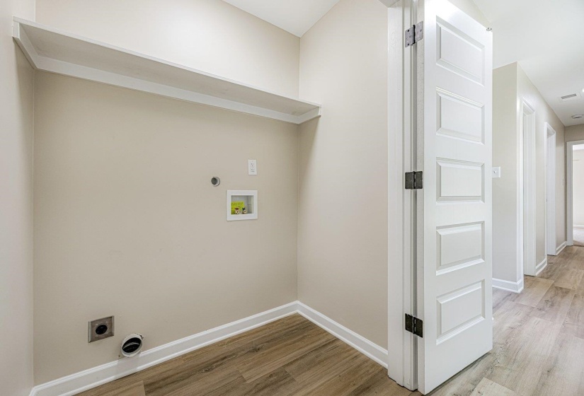 Laundry room with hookup for an electric dryer, light wood-style flooring, and washer hookup