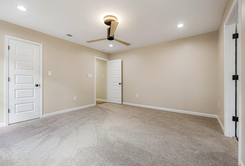 Unfurnished bedroom featuring light carpet, recessed lighting, and ceiling fan