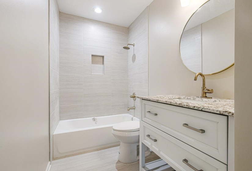 Bathroom with  shower combination, vanity, and light wood-type flooring