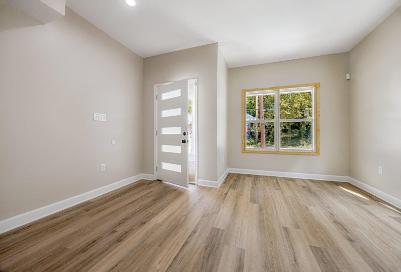 Foyer with light wood-style floors and recessed lighting